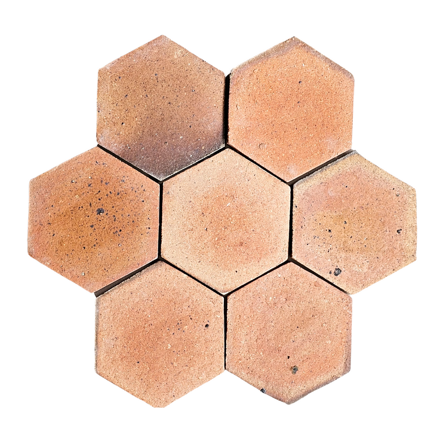 Six Atelier Clay Hexagon Mosaic Natural Stone tiles, with a reddish-brown terracotta look, are arranged on a white background in a symmetrical flower-like pattern—one tile centered, others radiating outward.
