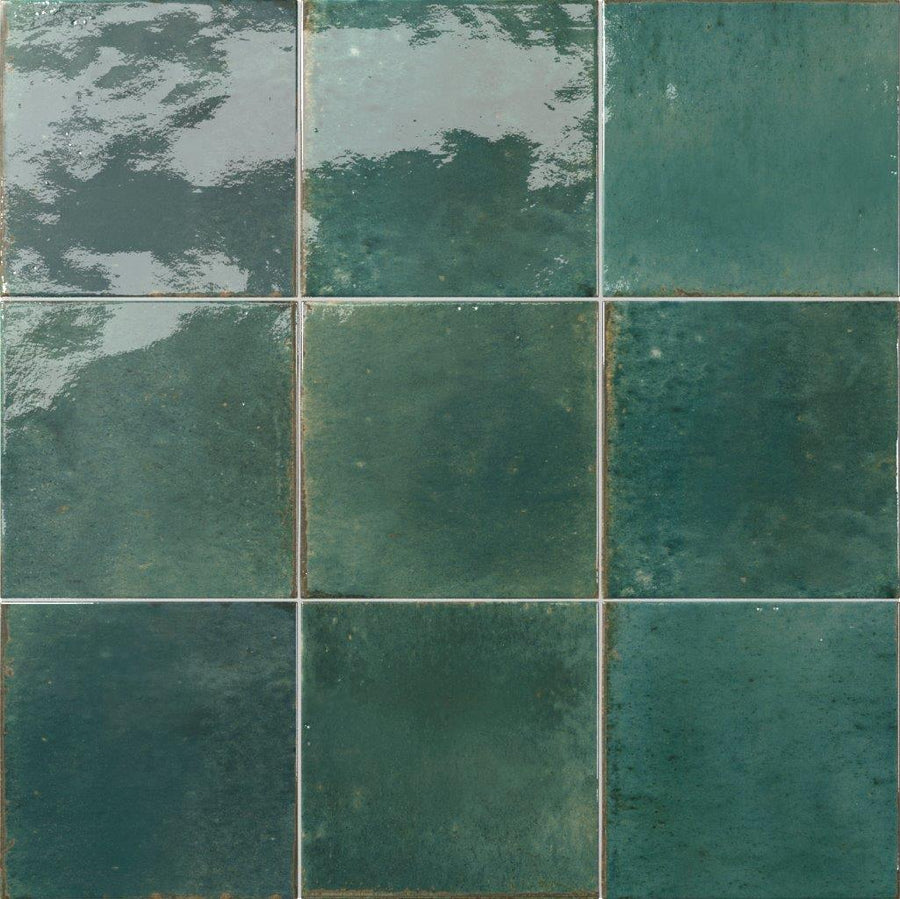 Nine Relic 5.8 x 5.8 Porcelain Tiles arranged in a 3x3 grid, each featuring glossy green finishes with varied shades, textured surfaces, and reflective, uneven coloration for a distinctive look.