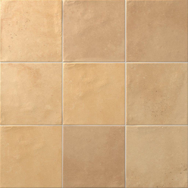 A close-up view of nine square Relic 5.8 x 5.8 Porcelain Tiles in beige, featuring subtle shade variation and slightly textured surfaces.