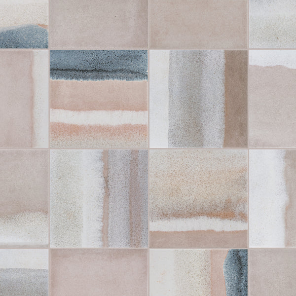 A grid of square ceramic tiles, each featuring a unique mix of beige, pink, white, and blue-gray abstract patterns and gradients, creating a soft, artistic, and modern mosaic effect.