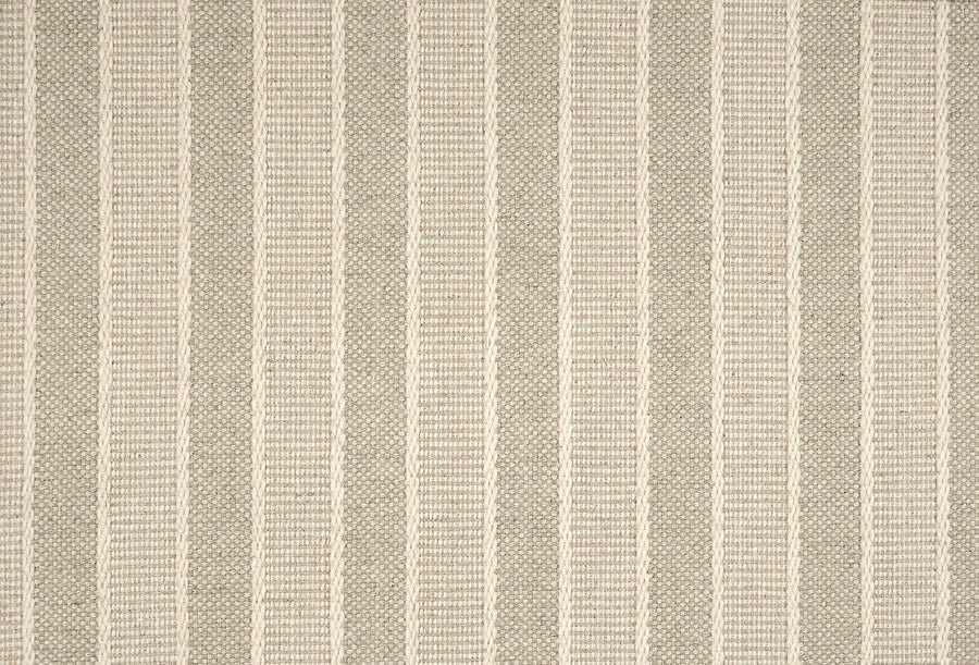 The Renegade Stripe On Trend Carpet features beige and light gray fabric with vertical stripes, combining textured solids and thin ribbed lines for a contemporary, neutral look in a durable luxury design.
