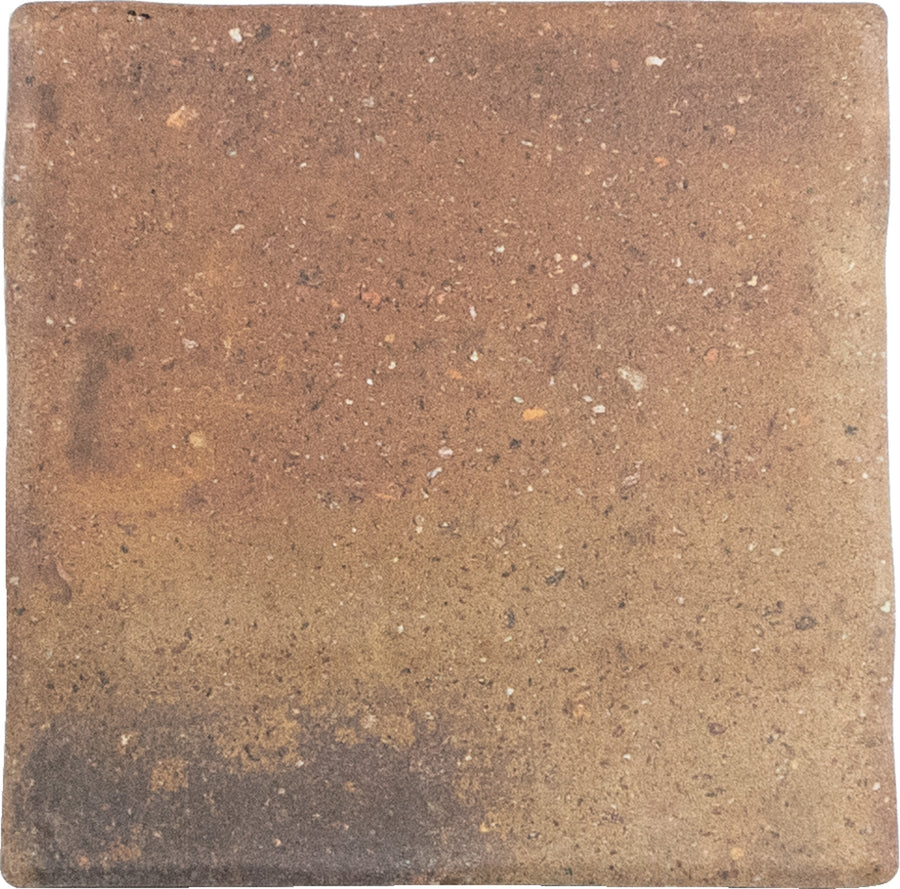 The Roots Small 4.3" x 4.3" Ceramic Tile in Rust features a square shape, rustic color, rough uneven surface, subtle variations, and speckles—ideal for statement floors with timeless character.