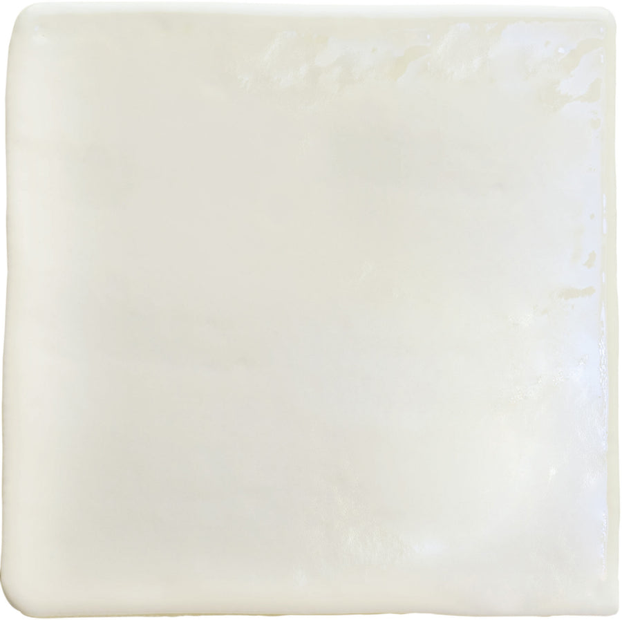 The Roots Small 4.3" x 4.3" Ceramic Tile in White Gloss features a smooth, glossy surface and slightly uneven edges, offering a luxurious tile look ideal for creating stylish statement floors.