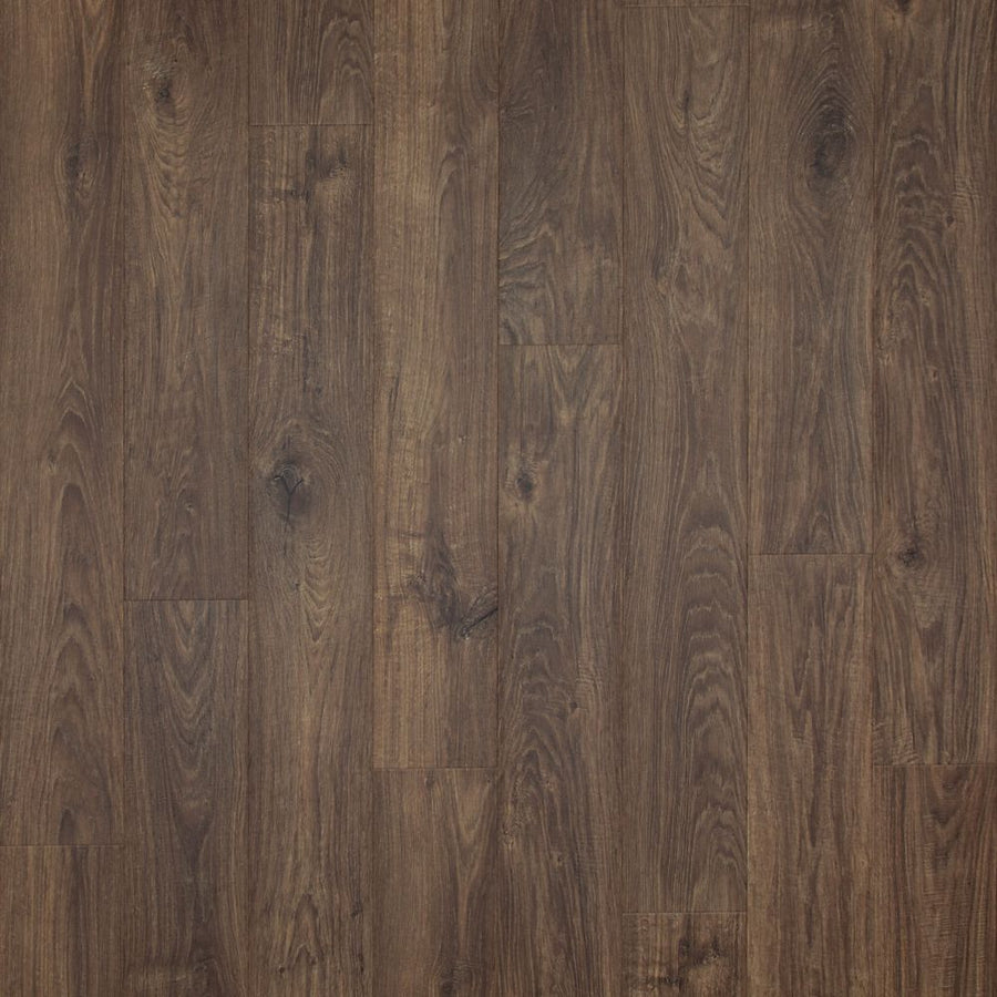 Close-up of Casita Terrace 7 1/2" Waterproof Laminate in Rustic Forest Oak, showing dark brown tones, wood grain patterns, knots, and color variation. Planks laid side by side highlight its natural texture and moisture resistance.