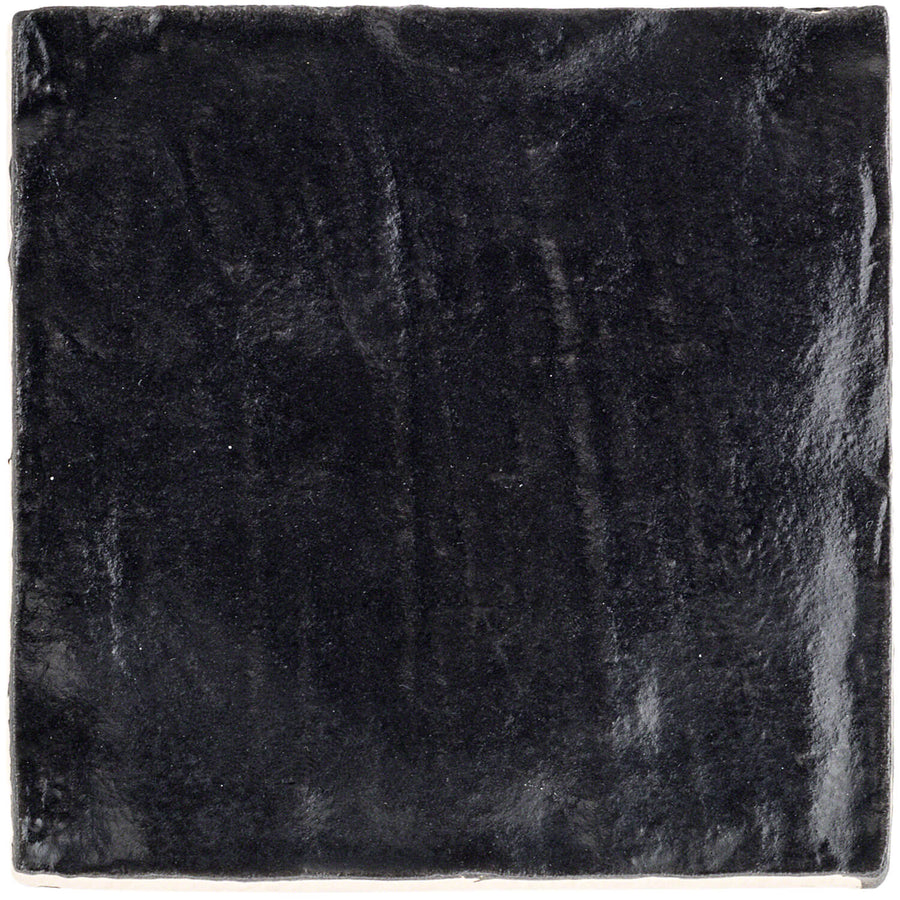 A close-up of the Myorka 4" x 4" Ceramic Tile in black, featuring a glossy finish with a slightly uneven surface and subtle texture—ideal for adding modern style to your kitchen backsplash.