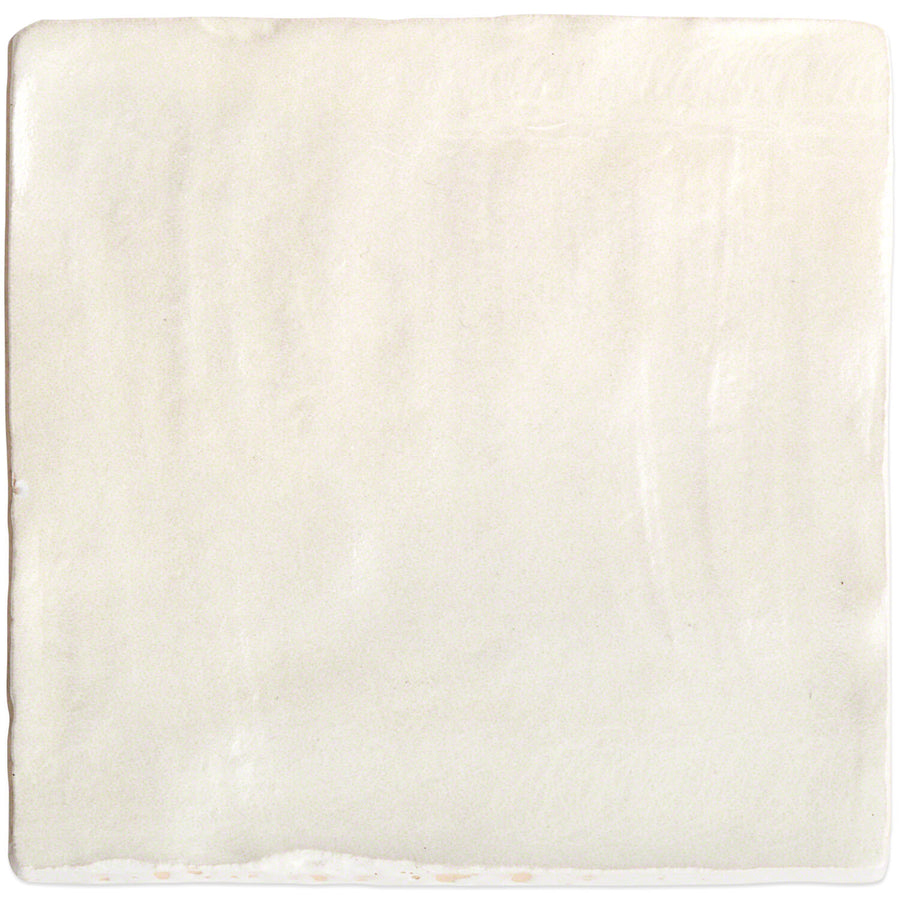 The Myorka 4" x 4" Ceramic Tile in Cream features a smooth, slightly uneven surface with subtle brush strokes and texture variations, making it perfect for a stylish kitchen backsplash.
