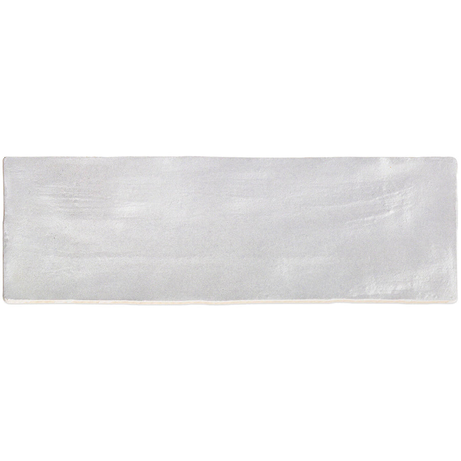 Rectangular Myorka 2" x 8" grey subway tile with a slightly uneven, handmade texture and a subtle glossy finish—ideal for a unique kitchen backsplash or accent wall.