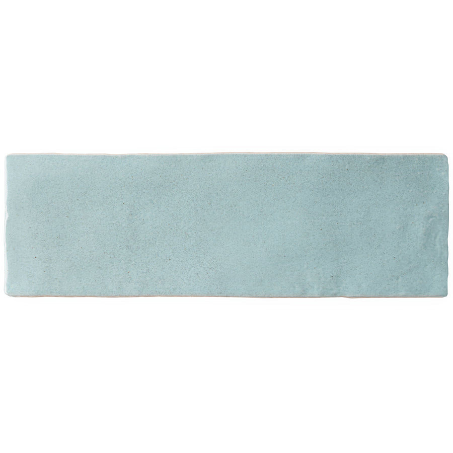 The Serena 3" x 8" Subway Tile in Aqua features a slightly uneven, handmade texture and edges. Ideal for floors or accent walls, this rectangular tile is shown isolated on a white background.