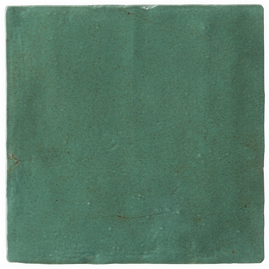 The Serena 4" x 4" Ceramic Tile in green features a smooth, matte finish and gently uneven edges. Subtle texture variations and natural imperfections give it a handcrafted look, perfect for backsplashes or accent walls.