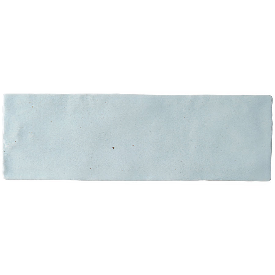 A single Serena 3" x 8" Subway Tile in Sky, featuring a subtly uneven surface and edges, photographed on a white background—ideal for accent walls or stylish floor installations.