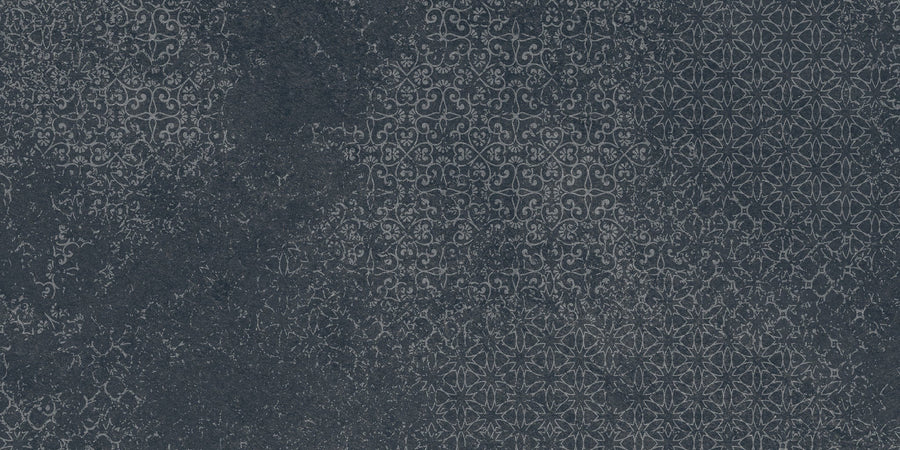 Shyft 12x24 Lace Deco features a dark textured surface with an intricate, repeating geometric and floral pattern in subtle lighter grey tones, reminiscent of vintage Brazilian slate for a look of faded elegance and ornate charm.