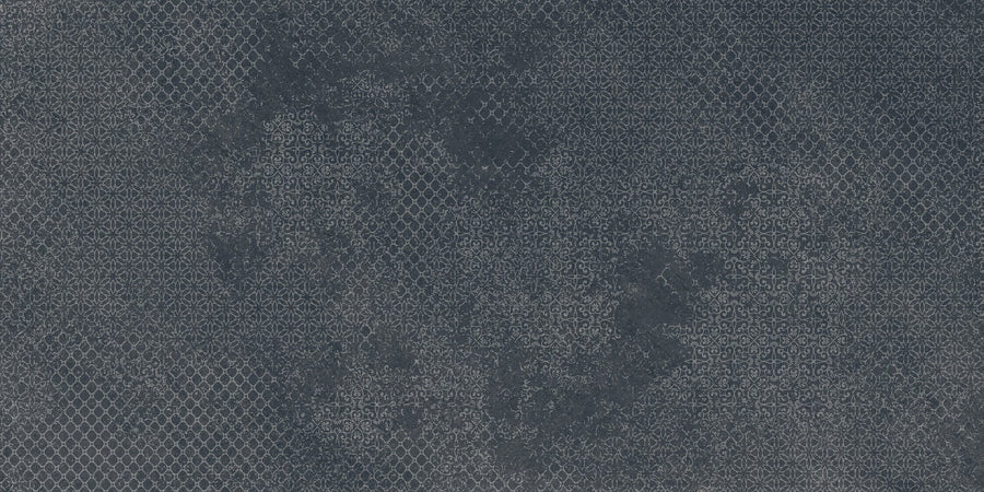 Shyft 24x48 Lace Deco features a dark gray porcelain tile with a subtle, intricate geometric pattern resembling small floral motifs, inspired by vintage wallpaper and classic Brazilian slate. This rectified tile brings timeless elegance to any space.