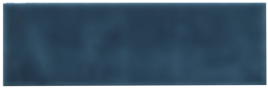 The Zephyr 2.5x8 Ceramic Tile is a rectangular, glossy Mediterranean tile in dark blue with subtle color variations and a smooth, reflective surface. Special-order for unique projects.