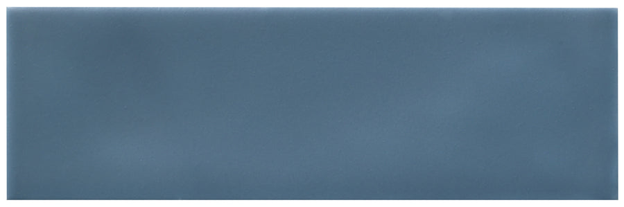 The Zephyr 2.5x8 Ceramic Tile is a rectangular tile in a muted Mediterranean blue with a smooth matte finish.