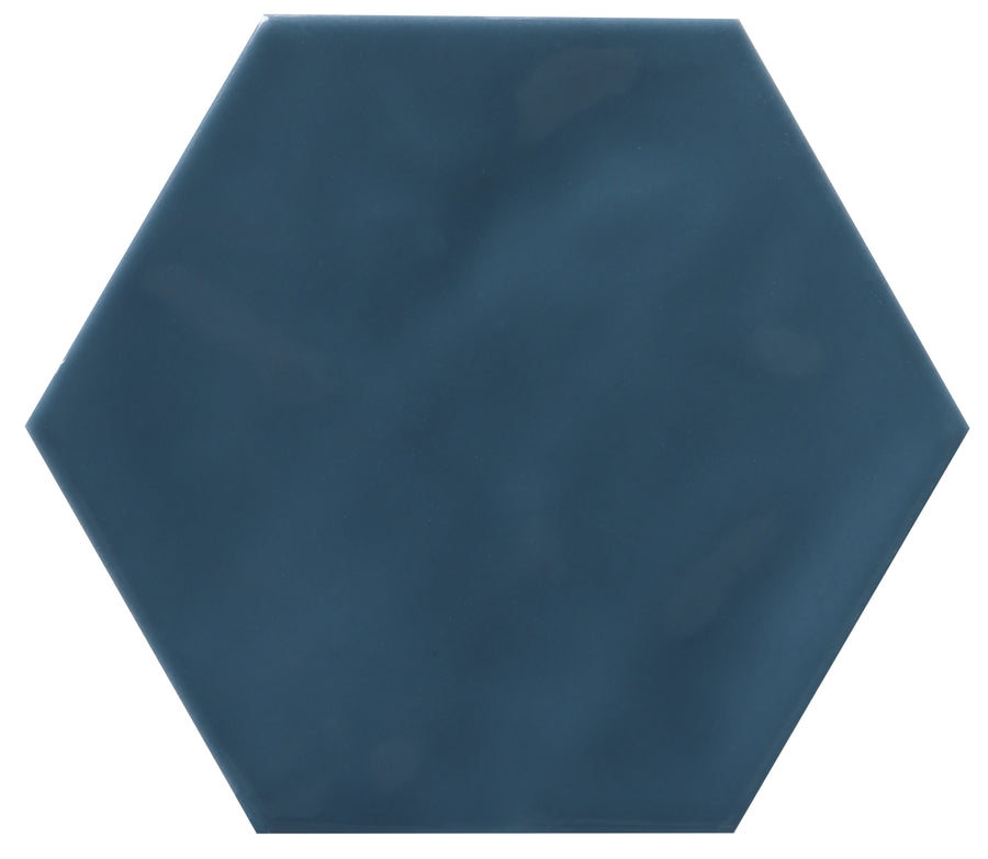 The Zephyr 4.2x4.9 Hexagon Ceramic Tile features a dark blue, glossy Mediterranean finish with smooth hexagonal edges and a slightly mottled surface, displayed on a white background. Special-order only.