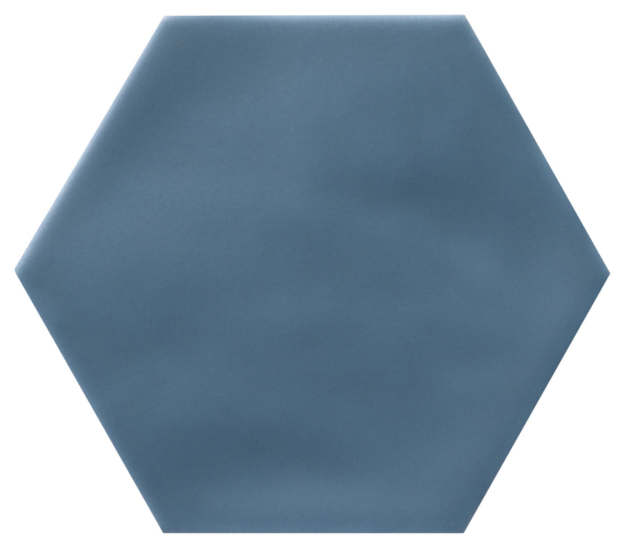 The Zephyr 4.2x4.9 Hexagon Ceramic Tile features a solid blue, matte-finished, smooth surface in Mediterranean style. Shown against a white background. Special order available.