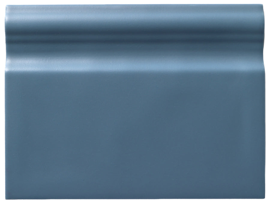 The Zephyr 6x8 Ceramic Baseboard, a blue rectangular tile with a smooth surface and a raised top edge from our handcrafted luxury collection, is shown against a plain white background.