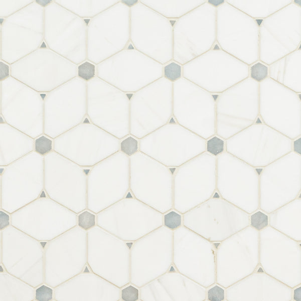 Stargaze Gray Polished Mosaic features white hexagonal tiles with small gray diamond-shaped inserts, forming a geometric pattern. Its smooth, glossy surface and subtle color variations offer a refined look in Stargaze Gray Polished.