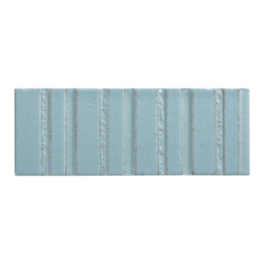 The Sarmento 3" x 8" Deco Subway Porcelain Tile in Celdor features a premium rectangular design with linear vertical textured ridges evenly spaced across its surface.