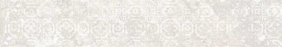 The Stream 4x24 Surfaces Rectified Porcelain Tile features a rectangular panel with a vintage travertine look, showcasing a subtle white ornate pattern on light beige and a weathered, distressed finish.