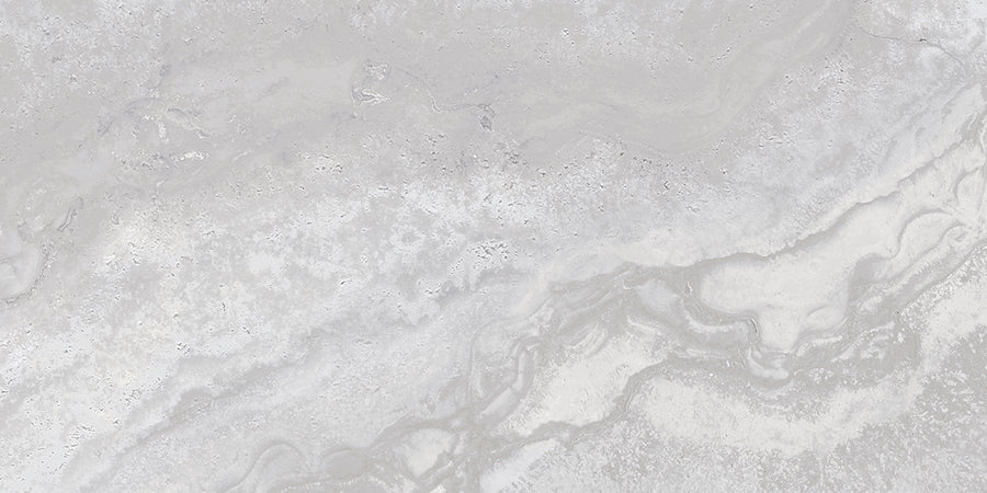 The Stream 12x24 Rectified Porcelain Tile features a light gray marble texture with subtle, wavy veining and soft, cloudy swirls for a smooth, travertine-inspired look.