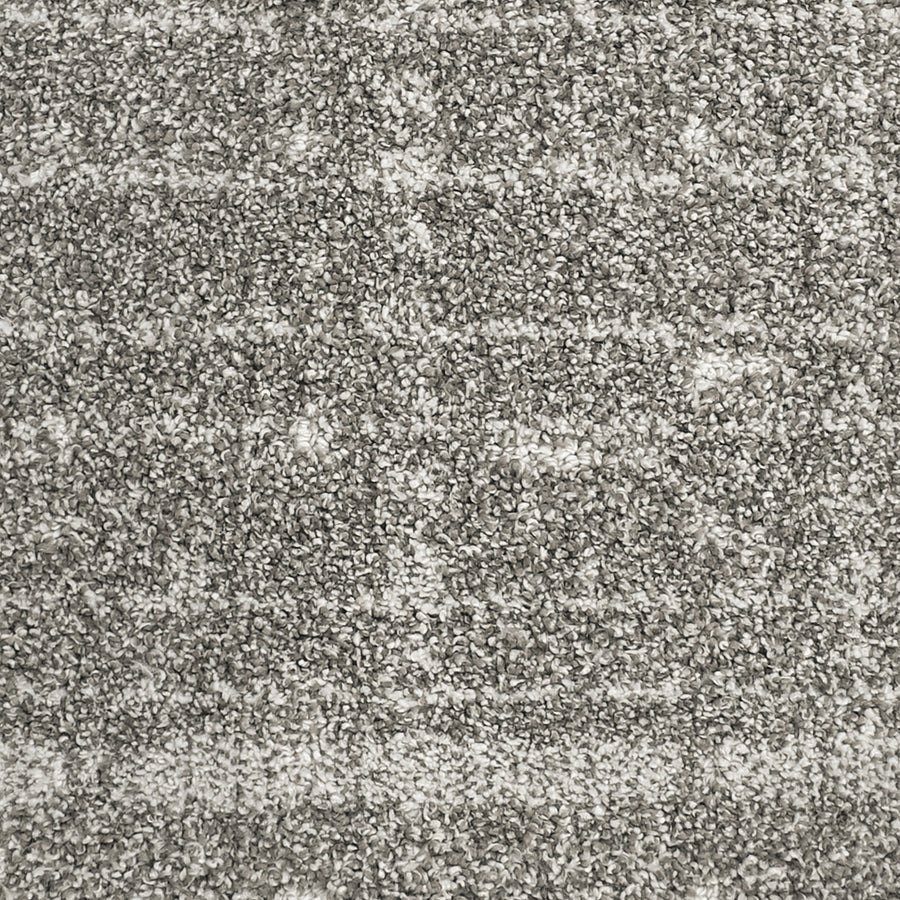Close-up of Furry Fun Pet Friendly Carpet shows a textured gray surface with mixed light and dark fibers, creating a soft, speckled pattern. The plush design offers comfort and durability, making it ideal for stylish pet-friendly interiors.