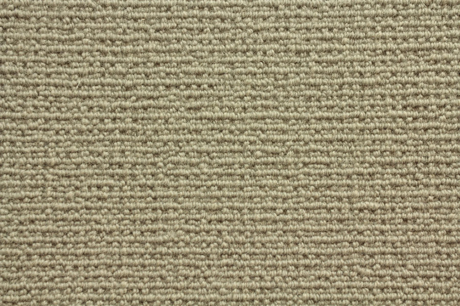 Close-up of Sequoia Berber Carpet in Sahara, featuring a beige looped pattern with tightly woven fibers. Its soft, uniform surface is crafted from premium materials, making it highly durable and ideal for high-traffic areas.