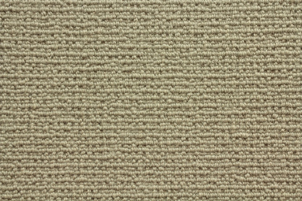 Close-up of Sequoia Berber Carpet in Sahara, featuring a beige looped pattern with tightly woven fibers. Its soft, uniform surface is crafted from premium materials, making it highly durable and ideal for high-traffic areas.