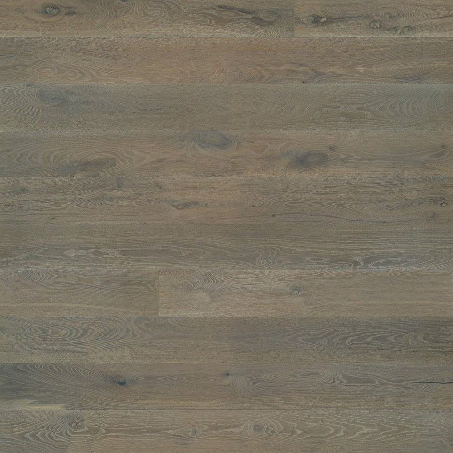 Provincetown 7 1/2" White Oak Hardwood features wide European White Oak planks in brown and gray tones, highlighting natural grain patterns and knots for a distinctive look.