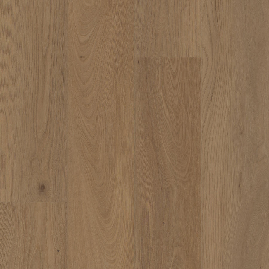 Close-up of Coretec Pro Plus XL Enhanced Vinyl flooring with light to medium brown planks, showcasing natural wood grain and knots for texture. Enjoy durable, waterproof flooring with authentic wood and stone looks.