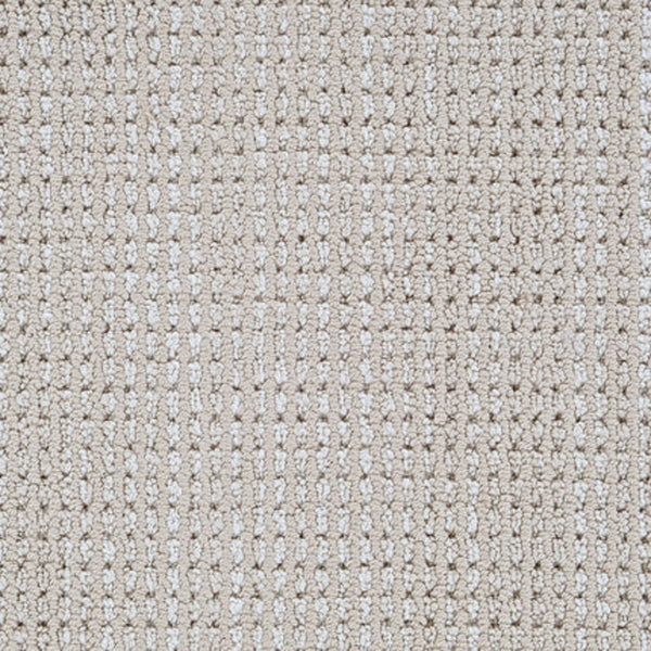 Close-up view of Top Notch Berber Carpet in Sand Castle, showcasing its grid-like woven texture with raised and recessed areas for a subtle checkered look; this premium flooring is also highly stain resistant.