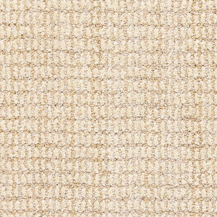 Close-up view of the Aspen Berber Carpet in Sand, featuring a looped, woven pattern. The soft, uniform surface has tightly packed fibers for durability and a subtle grid-like appearance.