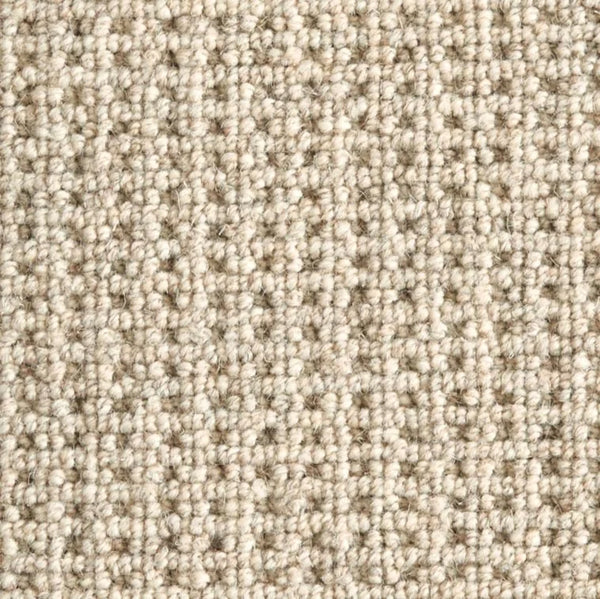 Close-up of Timbers Berber Carpet in Sandbar, featuring a looped pile and textured surface. Its tightly woven fibers create a soft, even feel with subtle neutral color variations—ideal for contemporary flooring.