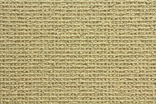 Close-up of Sequoia Berber Carpet in Sandstone—a light beige, tightly woven loop carpet made from premium materials, offering a textured look and lasting durability for high-traffic areas.
