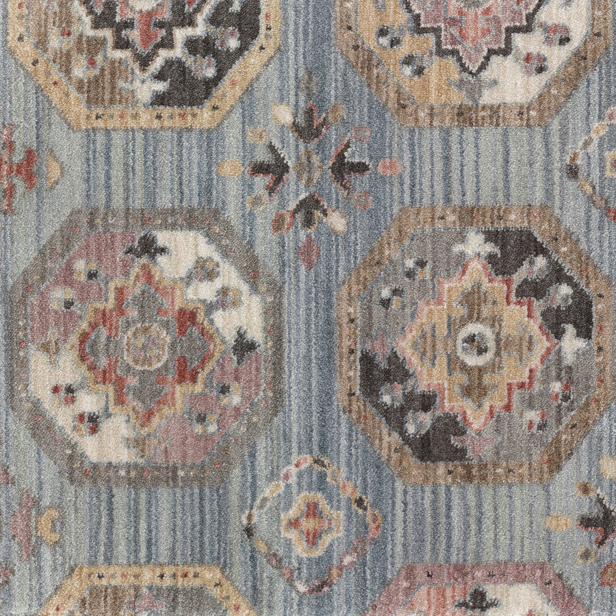 The Scotland On Trend Carpet features octagonal and diamond patterns in beige, gray, red, and black on a blue striped background with geometric and floral motifs—a stylish choice for contemporary interiors.
