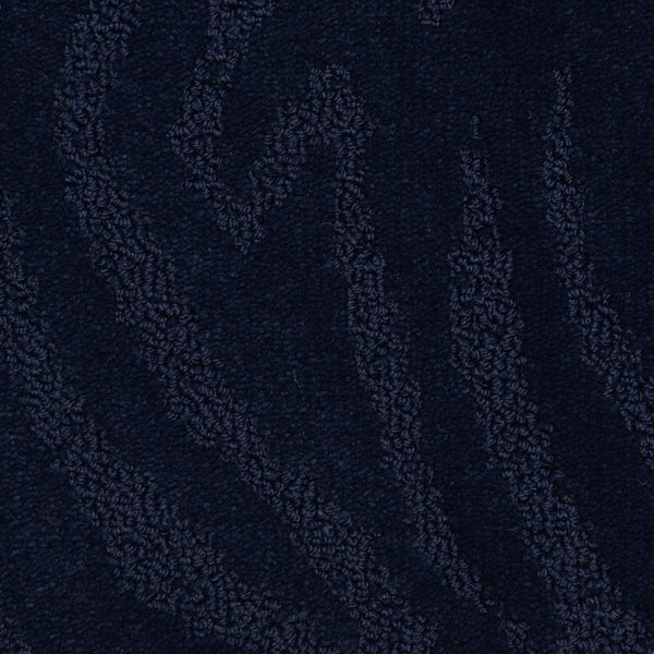 Capetown On Trend Carpet in Sea Point color features dark blue textured fabric with wavy, raised patterns. This plush carpet blends style and comfort, making it ideal for adding luxury and durability to high-traffic areas.