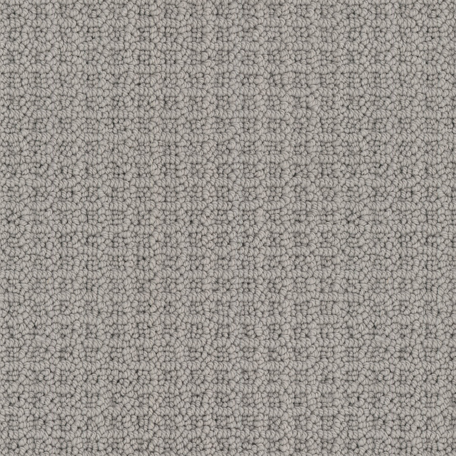 Close-up view of Seascape Berber Carpet in light gray, featuring classic loop-texture with small, rounded loops made from soft Envision nylon, creating a uniform, tightly woven and inviting surface.