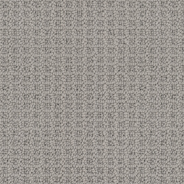 Close-up view of Seascape Berber Carpet in light gray, featuring classic loop-texture with small, rounded loops made from soft Envision nylon, creating a uniform, tightly woven and inviting surface.