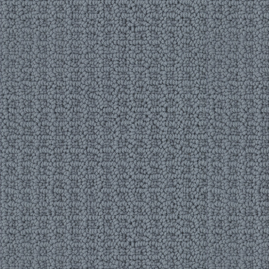 Close-up of Seascape Berber Carpet featuring a gray, looped pile pattern. The uniform and tightly woven texture creates a slightly raised, grid-like appearance across the surface.