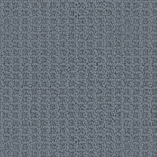 Close-up of Seascape Berber Carpet featuring a gray, looped pile pattern. The uniform and tightly woven texture creates a slightly raised, grid-like appearance across the surface.