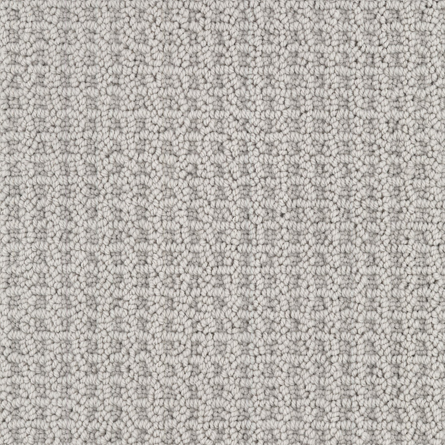 Close-up of Seascape Berber Carpet in light gray, featuring tightly looped fibers for a uniform and soft look. The consistent pattern showcases the detailed weave and stylish appeal of this carpet.