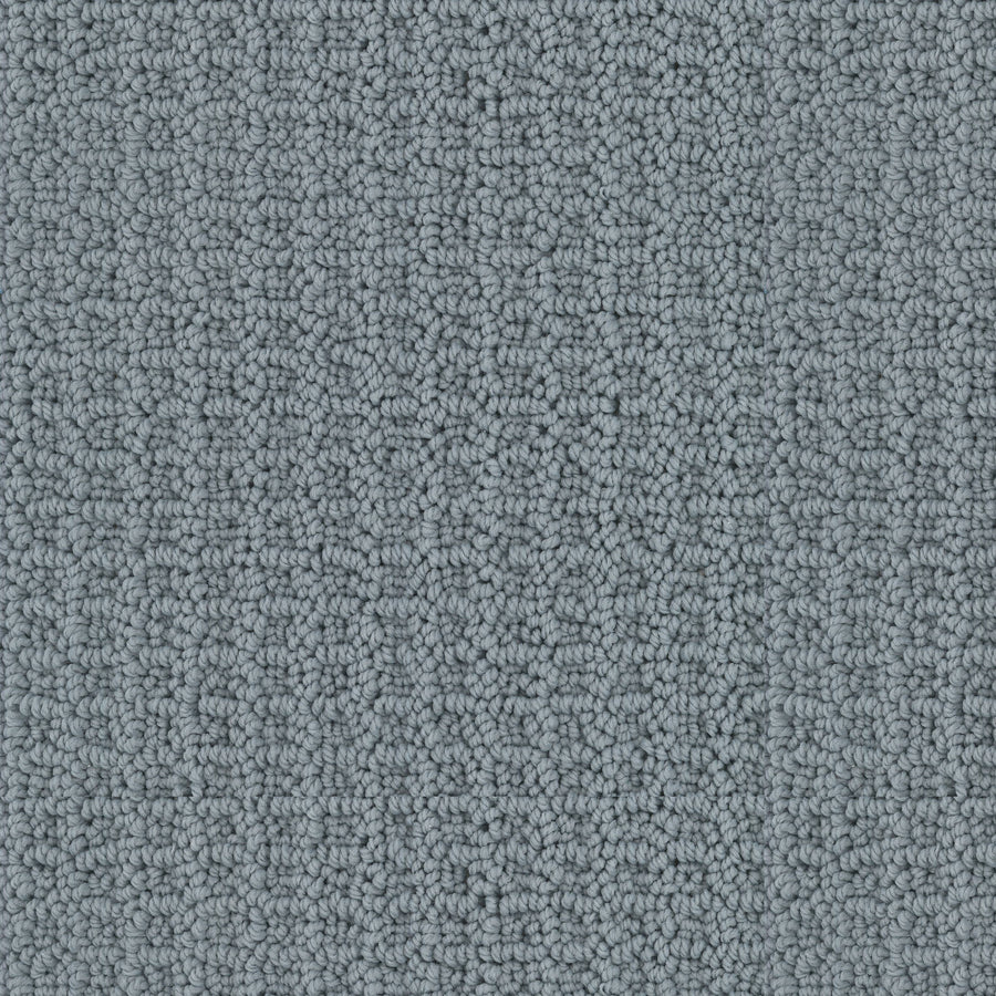 Close-up of the Seascape Berber Carpet in gray, featuring a textured loop-pile and subtle geometric pattern with tightly woven fibers for a soft, even surface.