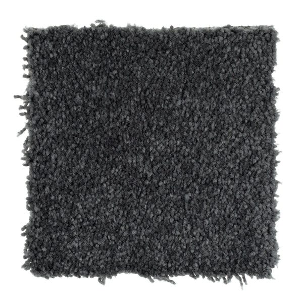 A square sample of Sensible Style III Family Friendly Carpet in Cove Blue features a dark gray textured look with slightly uneven edges on a white background, offering contemporary design and everyday comfort to any space.