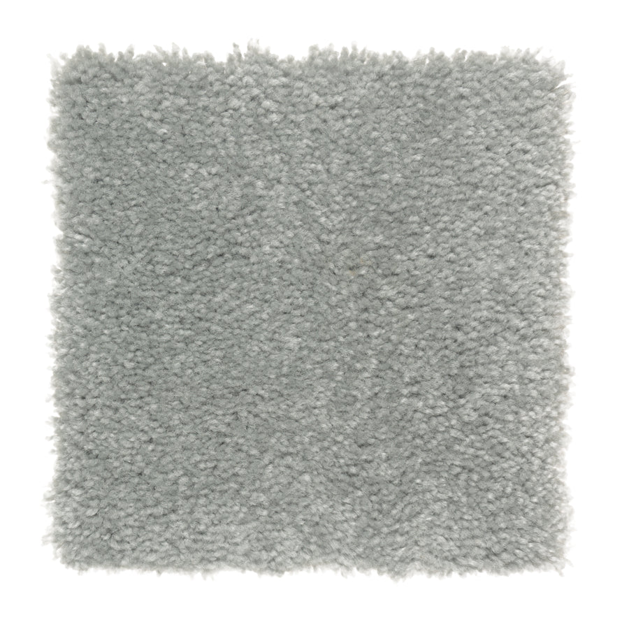 A square sample of Sensible Style III Family Friendly Carpet in Forgotten Statue showcases its light gray, plush, and textured look with a soft, fluffy feel, ideal for contemporary spaces, displayed on a white background.