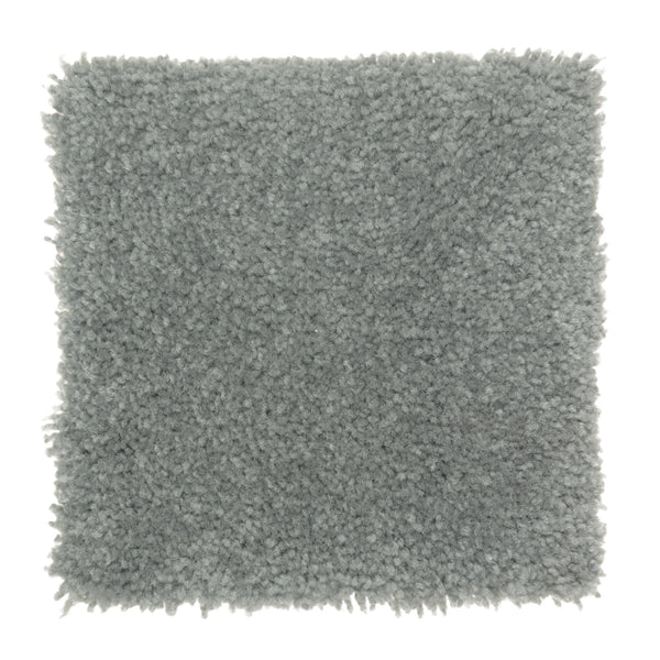A square swatch of Sensible Style III Family Friendly Carpet in Hanging Garden, featuring light gray, plush texture and a soft, fluffy look with slightly uneven edges—ideal for adding comfort to modern spaces.