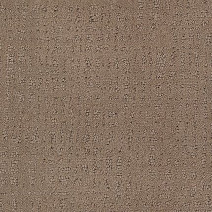 A close-up of Homage Berber Carpet in Shandur shows its brown, textured surface with a subtle, repeating square and rectangular pattern—perfect for high-traffic areas.