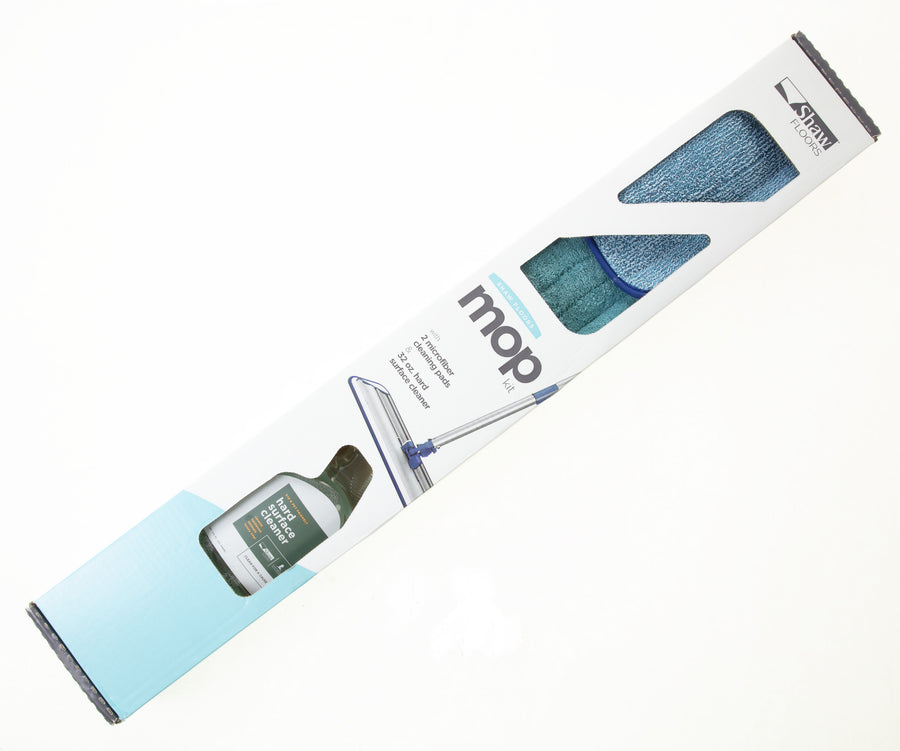 The Shaw Hard Surface Cleaning Kit comes in a mostly white box with light blue accents, displaying the microfiber mop, blue pad, and floor cleaner bottle for hard surface floors.
