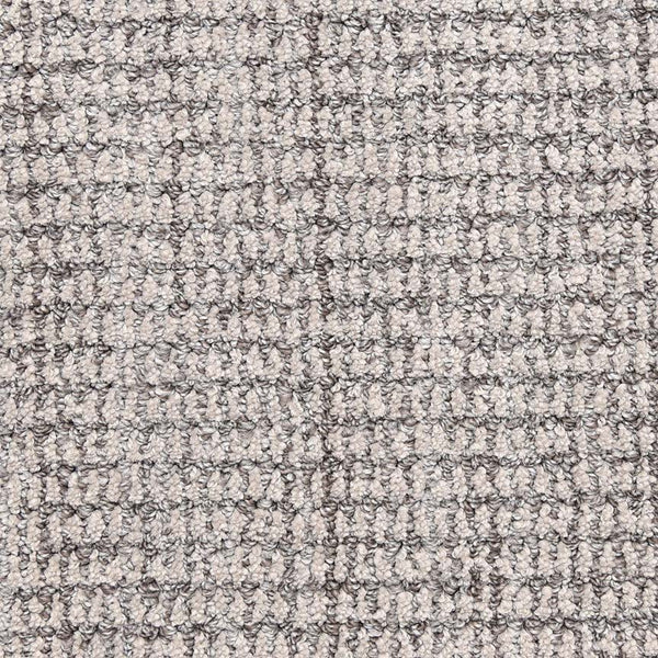 Close-up of Aspen Berber Carpet in Silver, featuring a soft, textured surface with a woven, grid-like pattern reminiscent of luxury carpeting.