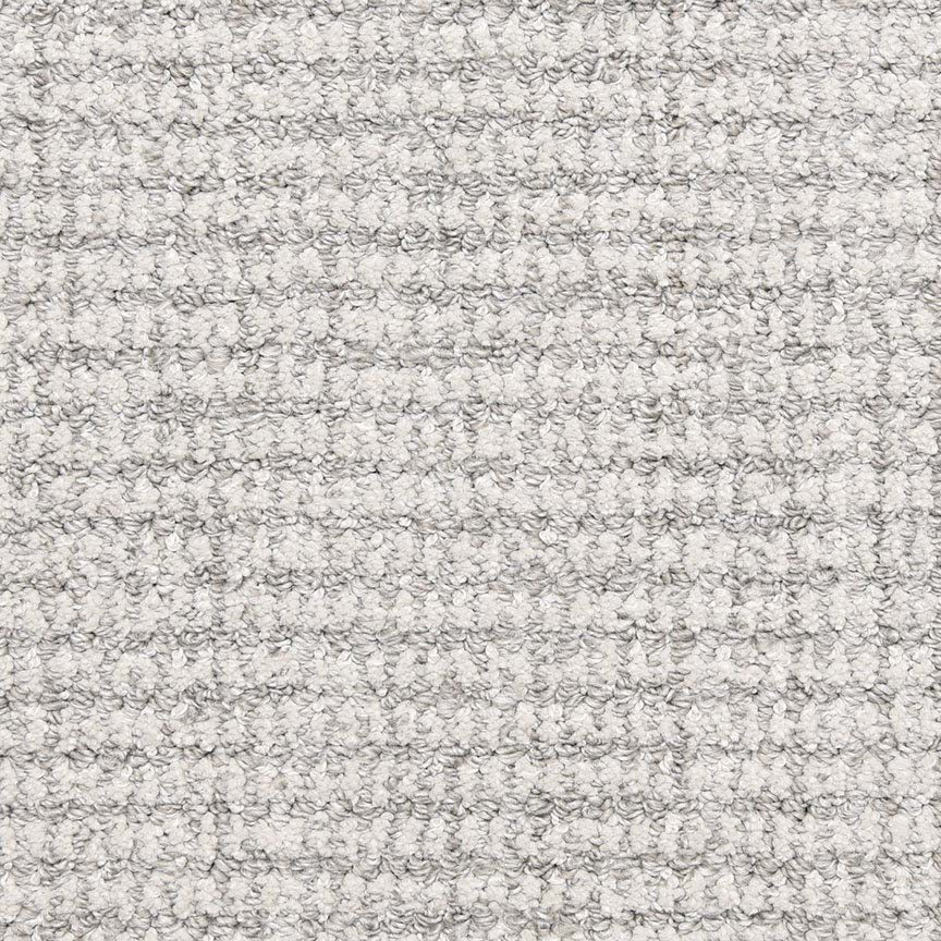 Close-up of Aspen Berber Carpet in Silver Jade, featuring a textured, tightly looped, light gray surface with a uniform grid-like pattern reminiscent of classic berber upholstery.