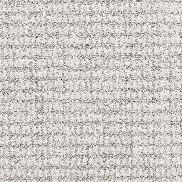 Close-up of Aspen Berber Carpet in Silver Jade, featuring a textured, tightly looped, light gray surface with a uniform grid-like pattern reminiscent of classic berber upholstery.